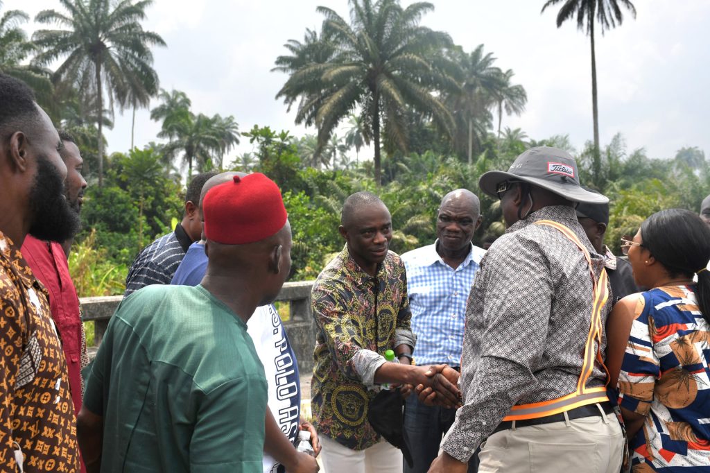 Engr Ojarigho Eghwrudje deputy director ministry of works highways and urban roads in a hand shake with the Honourable Commissioner for Work Urban Roads and Highways Comr. Reuben Izeze at the project site in Umeh Isoko South local Government Area.